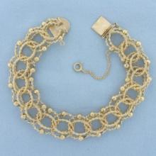 Wide Twisting Loop Rope Charm Bracelet In 14k Yellow Gold