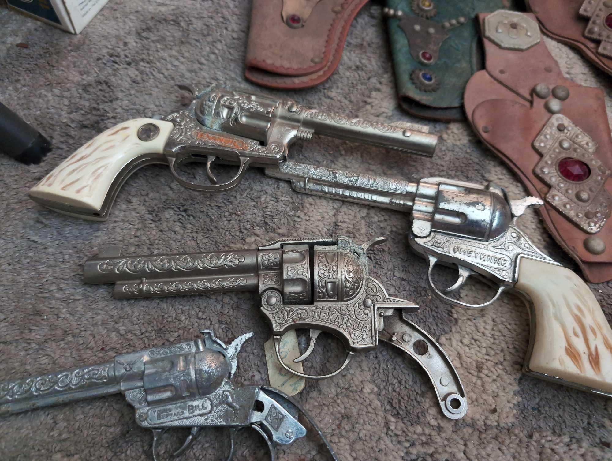 (LR) (3) BAGS FULL OF VINTAGE COWBOY CAP GUN REVOLVERS, HOLSTERS, & SPURS. BRAND NAMES INCLUDE
