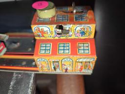 (LR) WIND UP TIN TOY, MAIN STREET, THE TURN KEY WORKS HOWEVER THE STRING THAT OPERATES THE ACTION OF