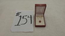 10k gold necklace, new in the box with ruby star design