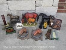 Various collectible horse statues and pictures