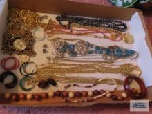 Assorted costume jewelry, including necklaces, earrings, chain belts