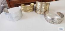 Silver and bronze colored cuff bracelets